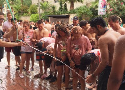 As is customary with La Tomatina, the locals are kind enough to hose us down after we have painted their town red with the blood of the tomato projectiles. Photo: Talyn Sherer