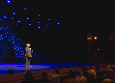 Park City Institute Executive Director Teri Orr and the audience inside the theater. Photo: @Lmsorenson.net