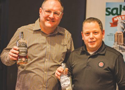 (L–R) Jeff Thompson, grand ambassador, and James Fowler, owner, of Sugarhouse Distillery show off their whiskey varieties that set them apart from others in the local industry. Photo: Talyn Sherer