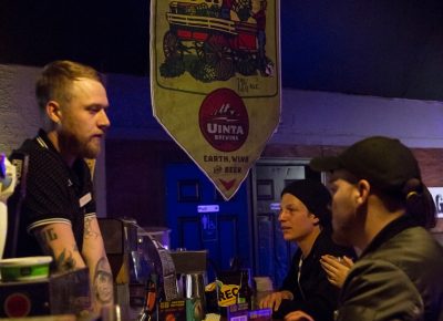 Some of the first patrons order drinks from the bartender at Urban. Photo: Jessica Bundy.