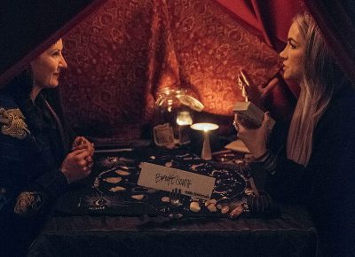 Brooke South gives a tarot card reading to SLUG’s own Angela Brown. Photo: Will Cannon