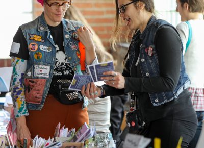 (L-R) Amy Lou from Wasted Ink Zine Distro in Phoenix and Andy Cooper from Viva Vox Press in Tempe talk zines and buttons at Grid Zine Fest at Publik Coffee on April 14.