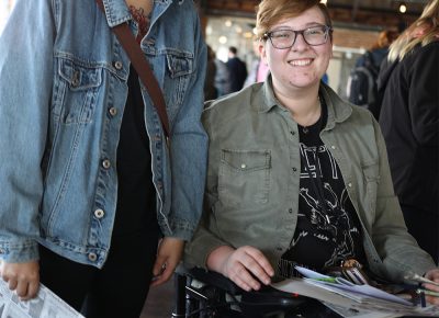 (L-R) Heidi Qin and Jae Miner wander from table to table. Qin loves independent publishing and she’s studying education. Miner is a fan of letterpress techniques.