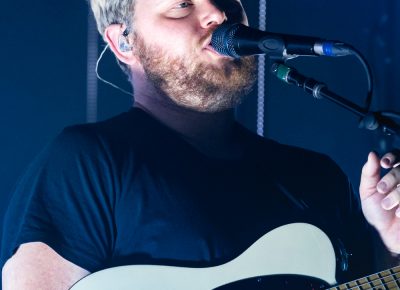 alt-J lead singer Joe Newman singing as the lights around him chaotically pulsate. Photo: Lmsorenson.net