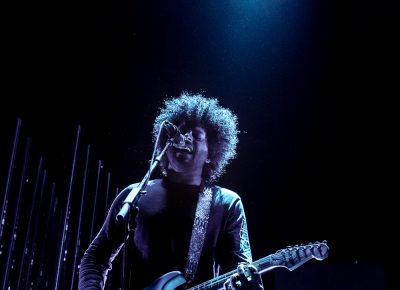 Twin Shadow sitting in the spotlight onstage in Salt Lake City. Photo: Lmsorenson.net