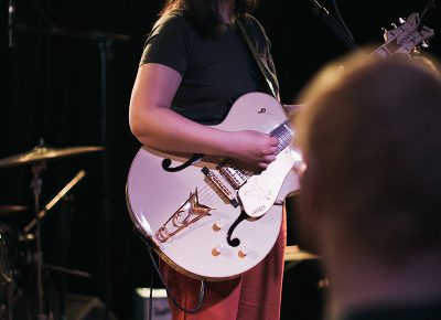 Dacus donning one of her two hollow body guitars of the evening.