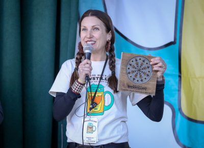 Angela Brown announces Brewstillery awards in four categories with plaques made by a local artisan. Photo: John Barkiple