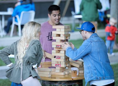 Beneath the bridge, a games area sponsored by Social Axe Throwing offered shade and distractions and feats of sobriety-testing dexterity. Only a confident Jenga player pulls blocks with a beer on the table. Photo: John Barkiple