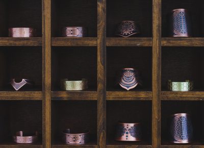 Some of the copper and brass cuffs made by House of Tebnebris sit on their beautiful display. Photo: Talyn Sherer