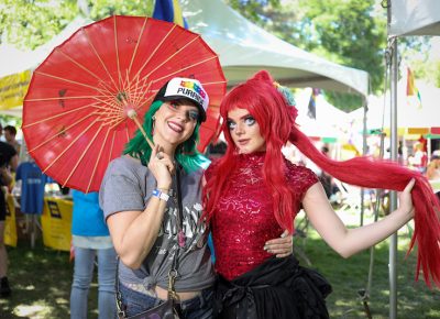 (L-R) Kelly and Madi have attended the pride parade since Madi was a baby. “School was challenging, definitely, but there were always teachers and other people that I knew that supported me and let me know that it was O.K. to be myself,” Madi said. Her mom, Kelly, agrees. “It seems easier than when I grew up here. I was not a Mormon, and people were like ‘whoa,’ but now it doesn’t matter.” Photo: John Barkiple