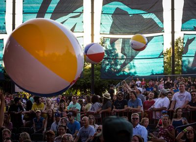 Bouncing Pepsi beach balls float above the crowd.