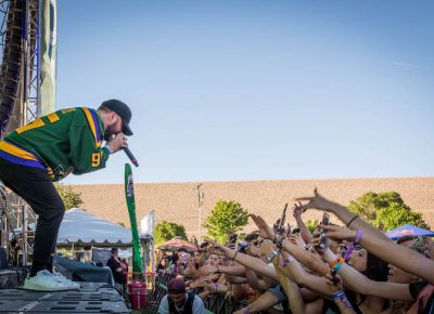 Quinn raps above the crowd.