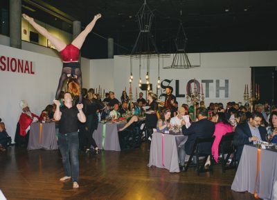 Guests watch as a performer balances above her partner. Photo: @clancycoop