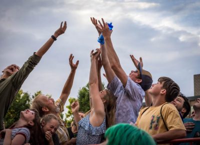 Fans reach for free merch thrown their way.