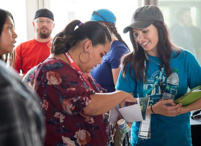 Craft Lake City Artisan and Programs Coordinator Shelbey Lang explains the benefits of Craft Lake City’s scholarship program to a participating parent in the Google Fiber STEM building.