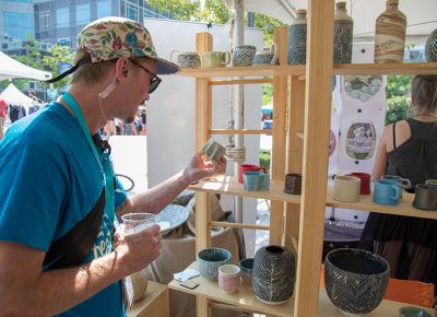 Craft Lake City Production Coordinator Tim Kronenberg takes a look at a 3D printed tea cup. Matt Sutton from Binary in the Google Fiber STEM building made it with one of his smaller robots.