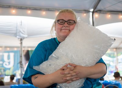 Craft Lake City Volunteer Coordinator Anne Olsen relishes the chore of ice delivery for the VIP Lounge. After another hot day on the Gallivan Plaza, it’s easy to see why that bag of ice is getting so much love.