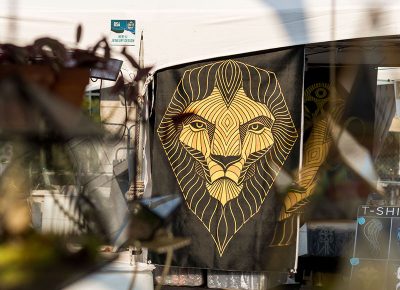 A giant lion tapestry hangs from the booths.