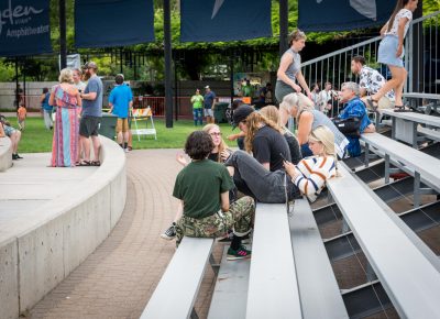 Friends relax on the bleachers.