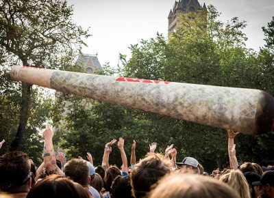 A giant joint bounces above the crowd.