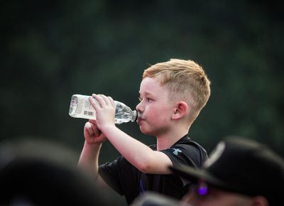 A young fan stays hydrated.