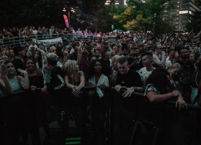 Fans feeling the bass from side stage.