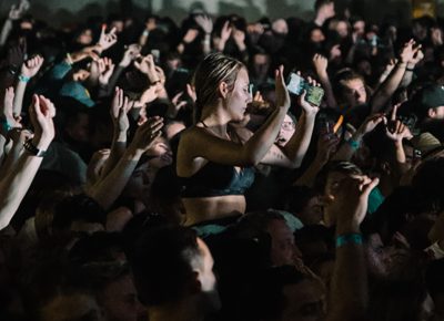 A fan sitting above the sea of people.