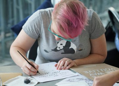 A student practicing the letters.