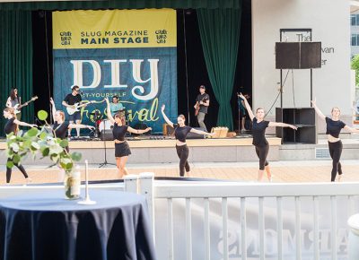 Performers in front of the SLUG Magazine stage.