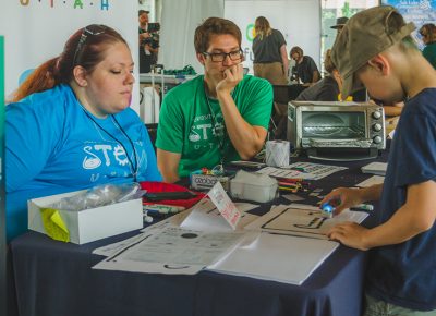 A young Craft Lake City DIY Festival goer discovers the power of electric paint.