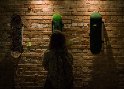 A guest admires the skate decks.