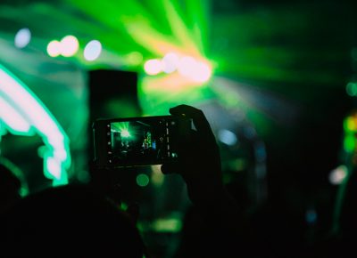 A fan taking a photo during the show.