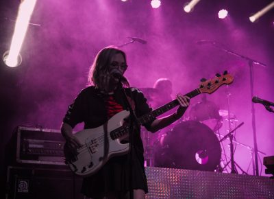 BORNS touring bassist holding down the rhythm section just upstage of her counterpart.