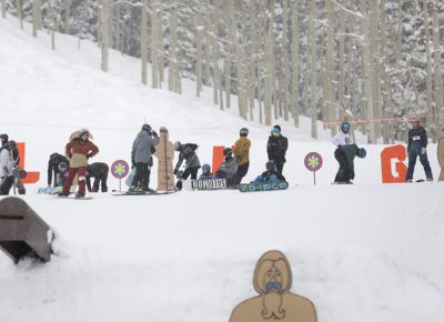 Snowboarders preparing for their next tricks.