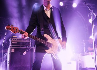 Bassist and punk rock devotee, Nathen Maxwell, on stage with bandmates. Photo: @Lmsorenson