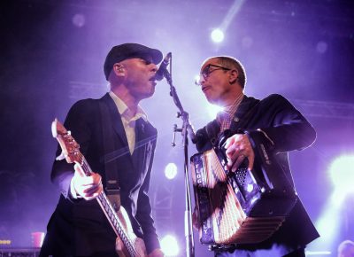 Bassist Nathen Maxwell and accordion player Matt Hensley sharing a mic for some backup vocals. Photo: @Lmsorenson