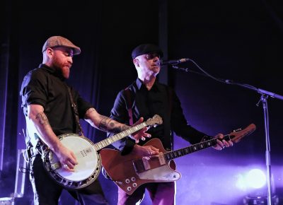 Bob Schmidt and Dennis Casey playing banjo annd guitar while providing back up vocals. Photo: @Lmsorenson