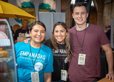 (L-R) Jenn Salazar, Ana Valdemoros and Keaton Hill work the Argentine’s Best Empanada booth at Brewstillerty. Valdemoros, district 4’s city council member, presented the award for best spirit— people’s choice. Photo: John Barkiple