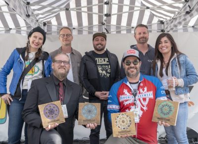 (L-R) Angela H. Brown, Ethan Miller, Ryan Manning, Alexander Ortega, Kelly Schaefer, Chris Hollands, Sylvia Hollands. Ana Valdemoros and Angela H. Brown rewarding Holystone Distilling co-owner and distiller Ethan Miller with the People's Choice: Best Brewstillery Cocktail. Photo: Jayson Ross