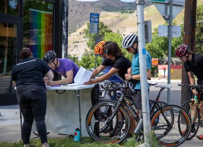 SLUG Magazine’s Joelle B. signs racers up for a mailing list outside of Blue Copper Coffee during an early stop in the SLUG Cat. Photo: Kaylynn Gonazlez