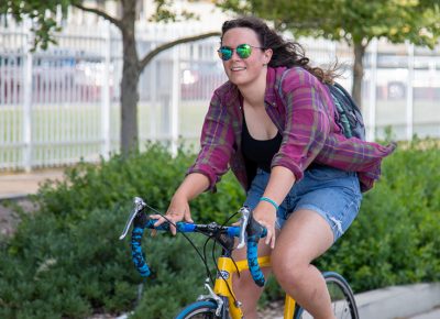 Natalie Kane rides on North Temple as she looks for the SLUG Cat check-in station at the State Fairpark. Photo: Kaylynn Gonazlez