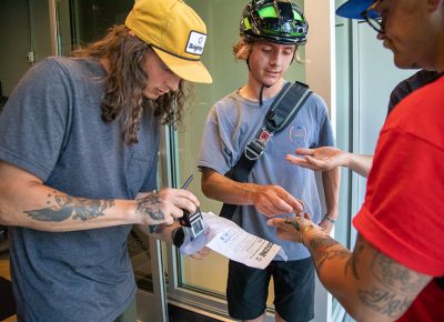 (L–R) SLUG Magazine’s Zach L. helps Zoltan Jelovich and Lizzy Dotlich complete a challenge at Craft by Proper in Sugarhouse. Jelovich heard about the 2019 SLUG Cat from the internet. He’s a bike messenger for Jimmy John’s, but he also rides mountain bikes in addition to his fixed-gear work bike. Photo: Kaylynn Gonazlez