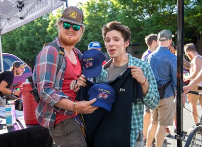 (L–R) Kent Boardman and Adrian Martin score some Fat Tire hats and shirts at SLUG Cat. Photo: Kaylynn Gonazlez