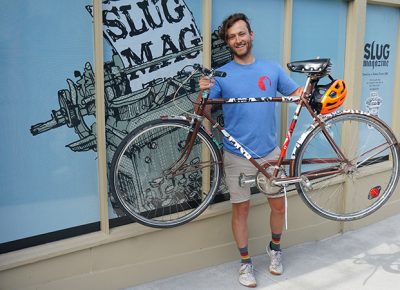 First-place winner Clint Campbell poses with his prize bike in front of the SLUG offices. Photo: Joshua Joye