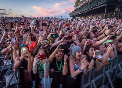 The crowd reaches towards Billie Eilish in anticipation and excitement. Photo: Colton Marsala