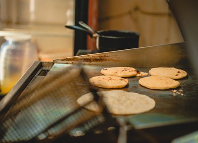 El Viroleño's nearly-finished pupusas on the grill.