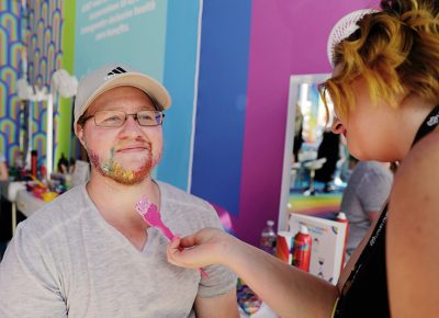 Glitter makeover! Attendees get their pride on and get all gussied up at Loveloud.