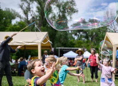 A young fan chasing a bubble.