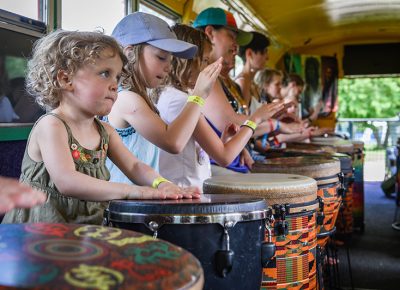 The young folks take part in drum bus sessions.