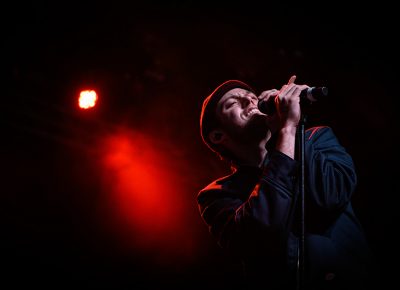 Bathed in red light, Harry Hudson soulfully croons to the crowd at the Complex.